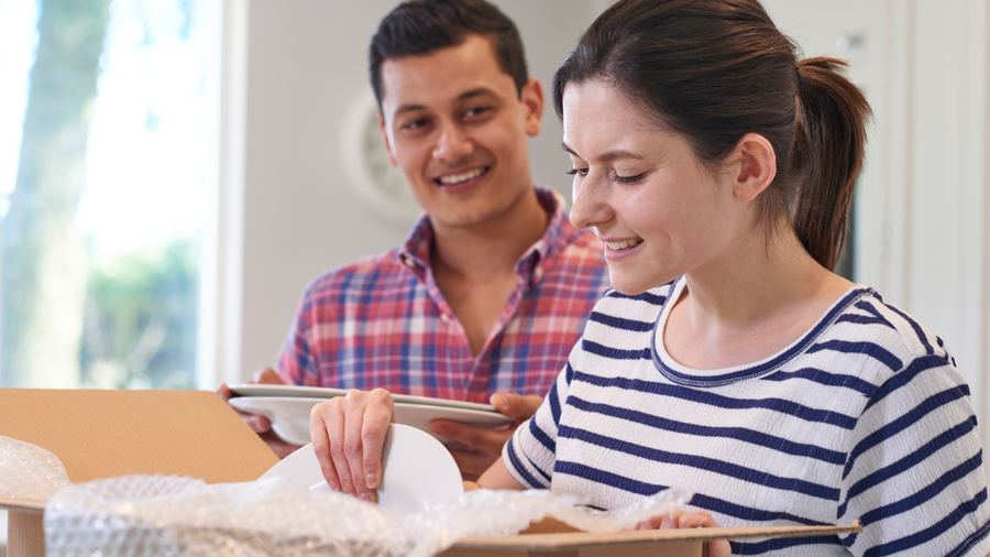 Couple unpacking boxes in a kitchen