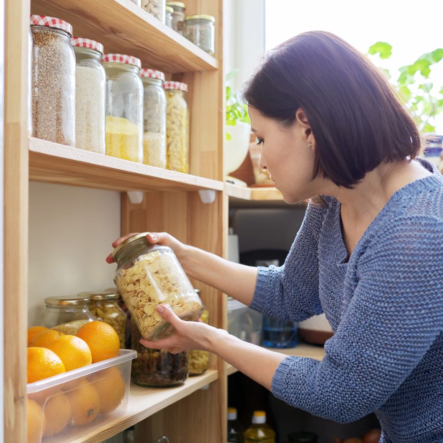 Woman organizing pantry jars